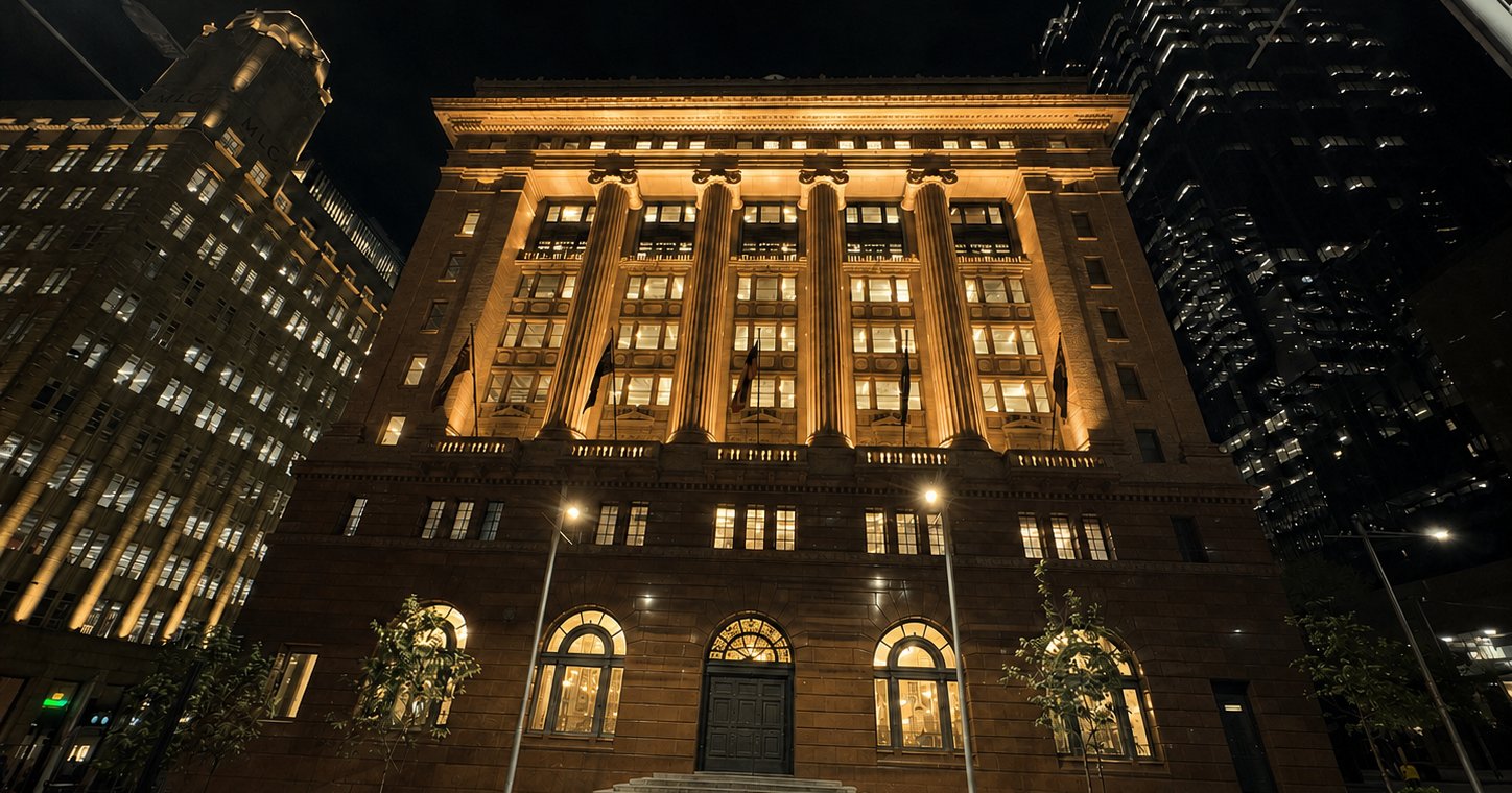 Multi-storey stone facade with warm architectural illumination at night